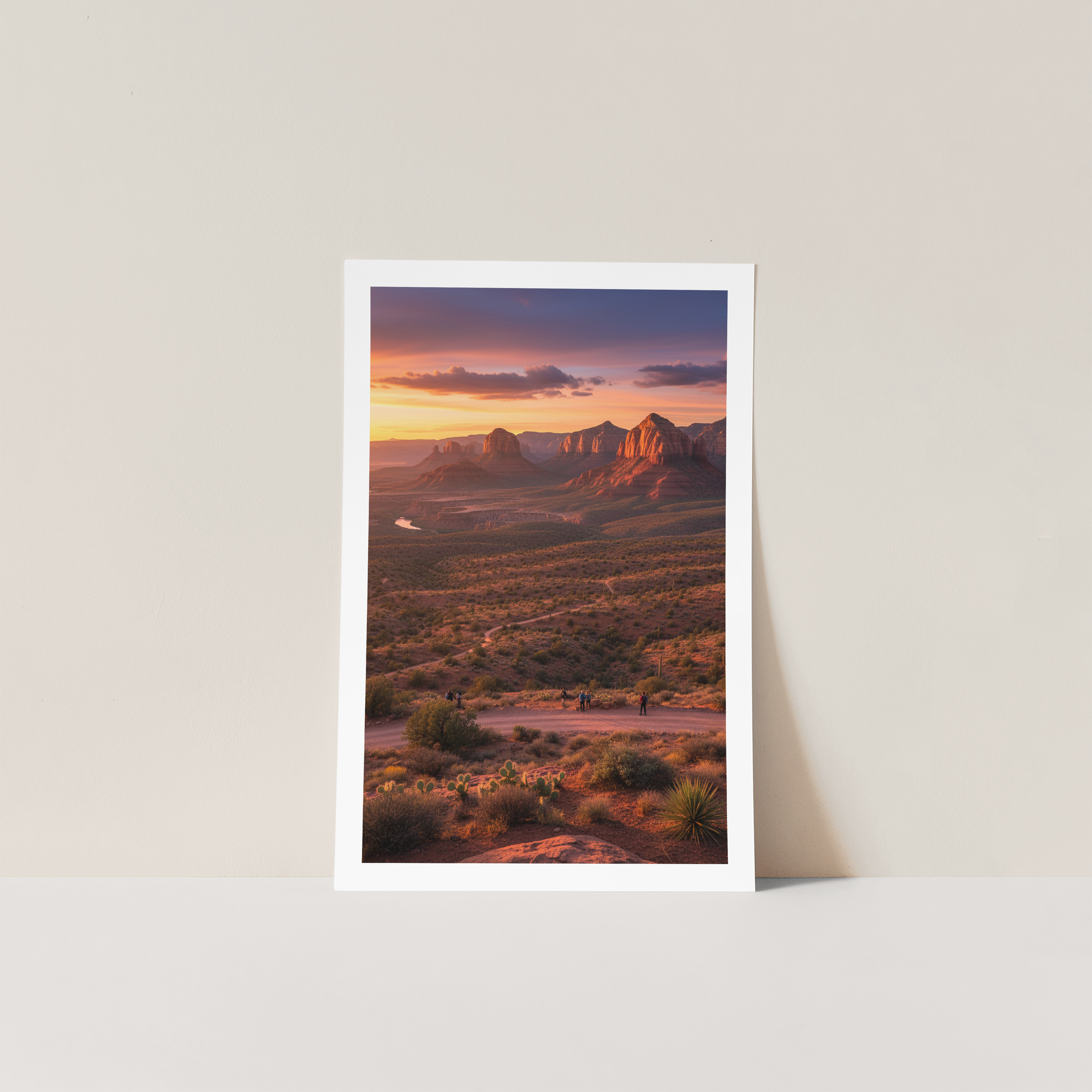 Framed photograph of a desert landscape with a sunset over mountains.