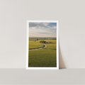 Framed print of a landscape with a green field and road in the USA. 